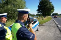 Policjanci sprawdzają prędkość pojazdów na drodze za pomocą laserowego miernika prędkości