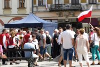 flaga Polski i wokół uczestnicy obchodów święta