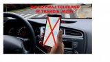 telefon w dłoni kierowcy, napis &quot;nie używaj telefonu w trakcie jazdy&quot;