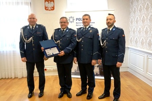 zdjęcie- policjanci pozują do zdjęcia i odbierają gratulacje