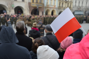 flaga Polski , w tle żołnierze