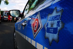 zdjęcie policjanta przy samochodzie, dzień, słonecznie