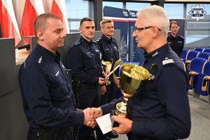 zwycięzca z pucharem w towarzystwie Komendanta Wojewódzkiego Policji w Katowicach nadinspektora Mariusza Krzystyniaka