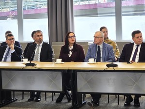 sala sesyjna, sztuczne światło, samorządowcy i policjanci zgromadzeni na sali siedzą i oglądają prezentację