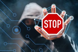 grafika-mężczyzna w kapturze, niewidoczna twarz, wyciągnięta ręka w niej znak z napisem STOP