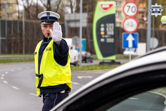 policjant z wyprostowaną ręką